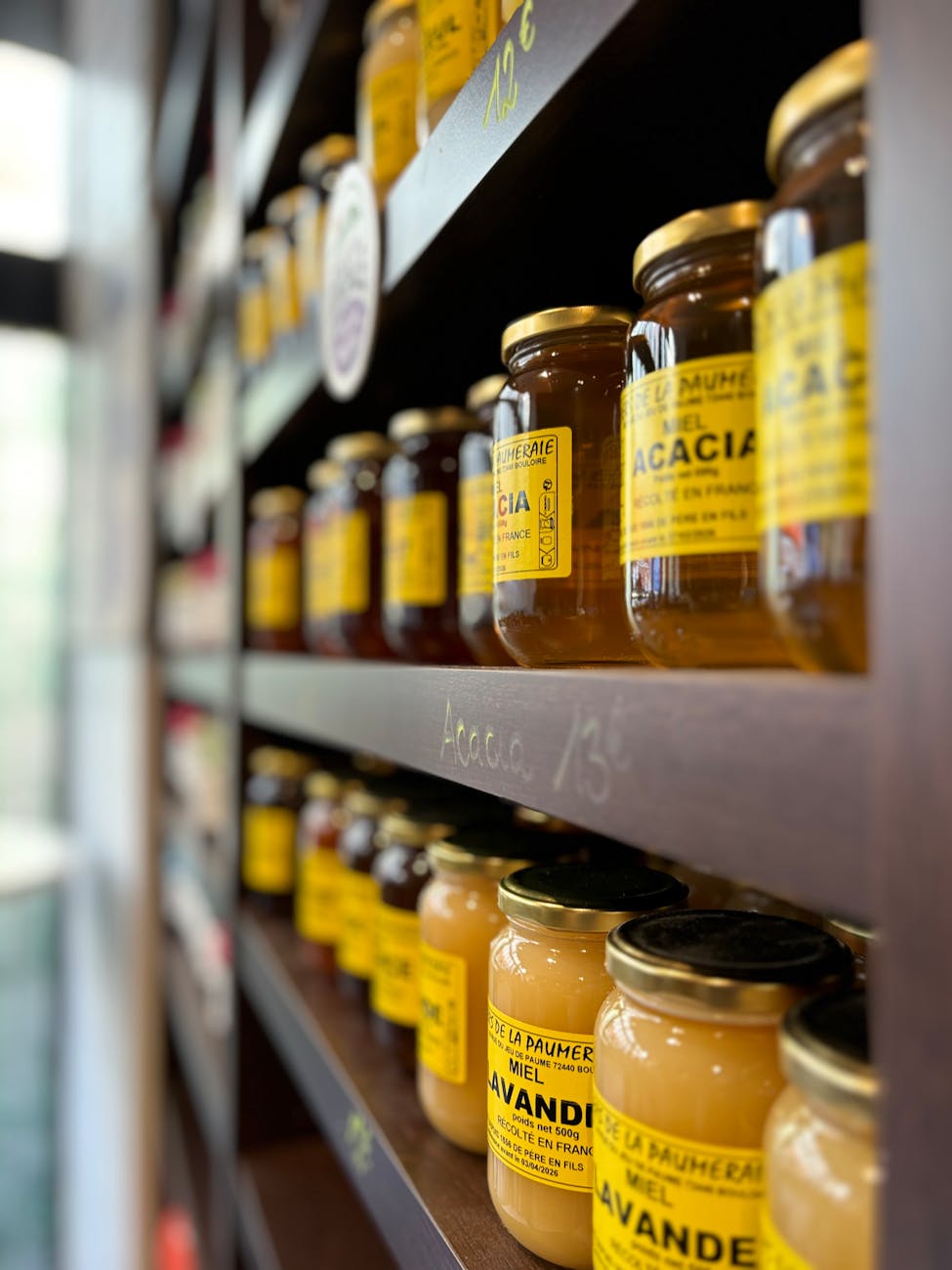 a shelf with jars of honey on it