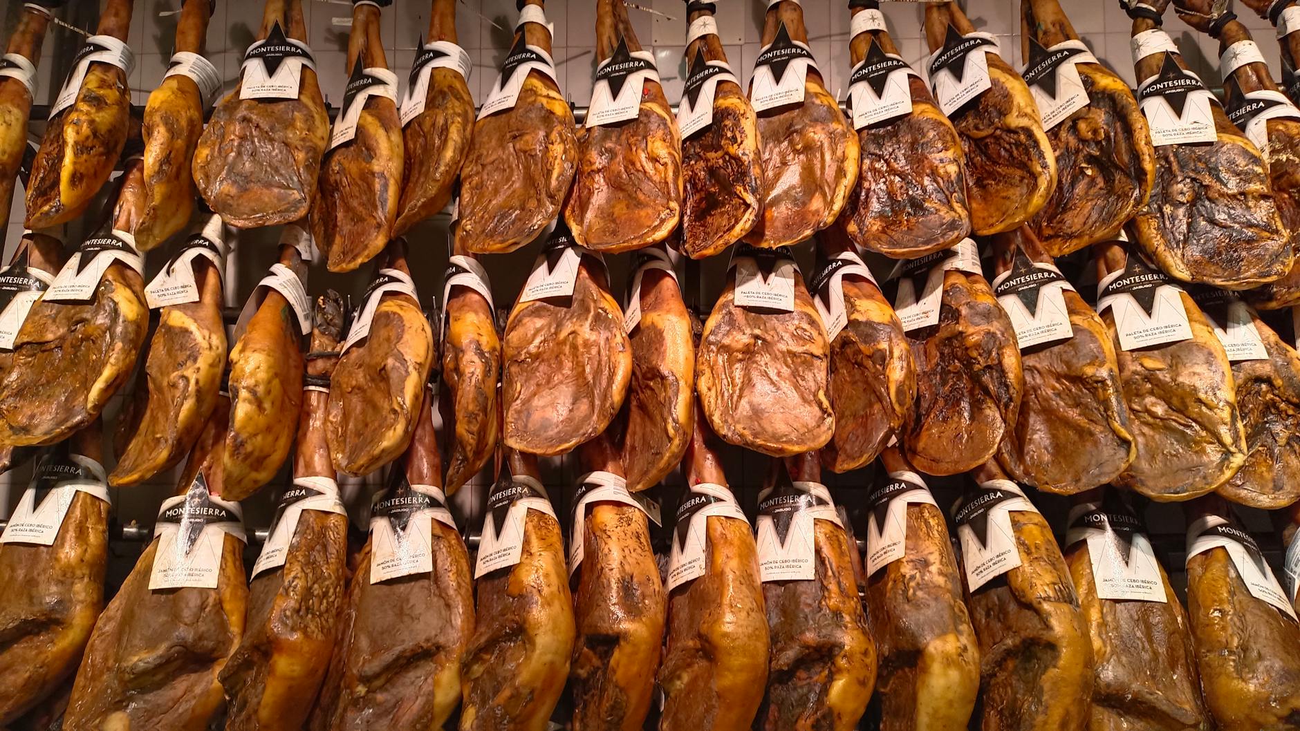 rows of jamon iberico ham hanging for display
